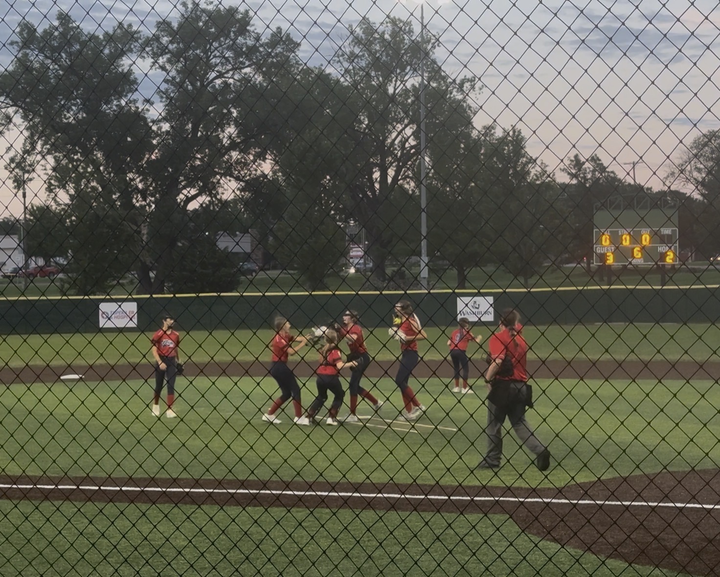 Pride teammates celebrating together on the field at dusk
