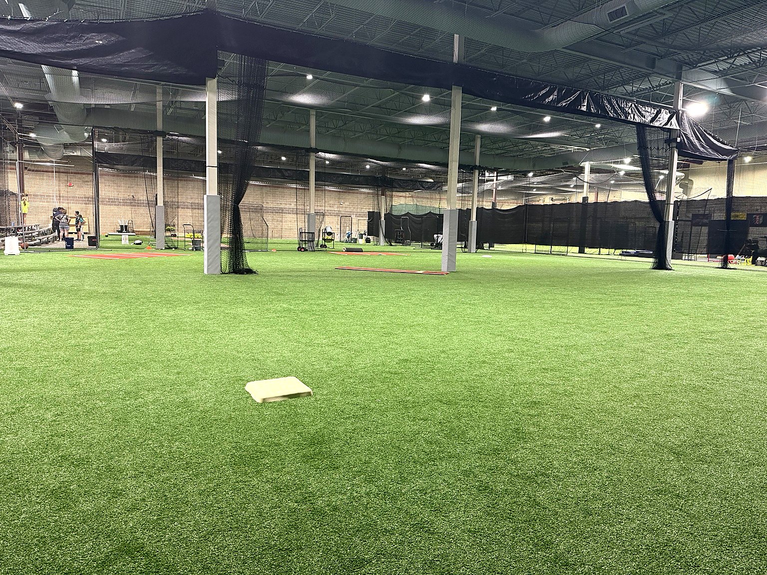 Top Tier Fieldhouse indoor softball training facility with full turf field and batting cages in Shawnee, Kansas